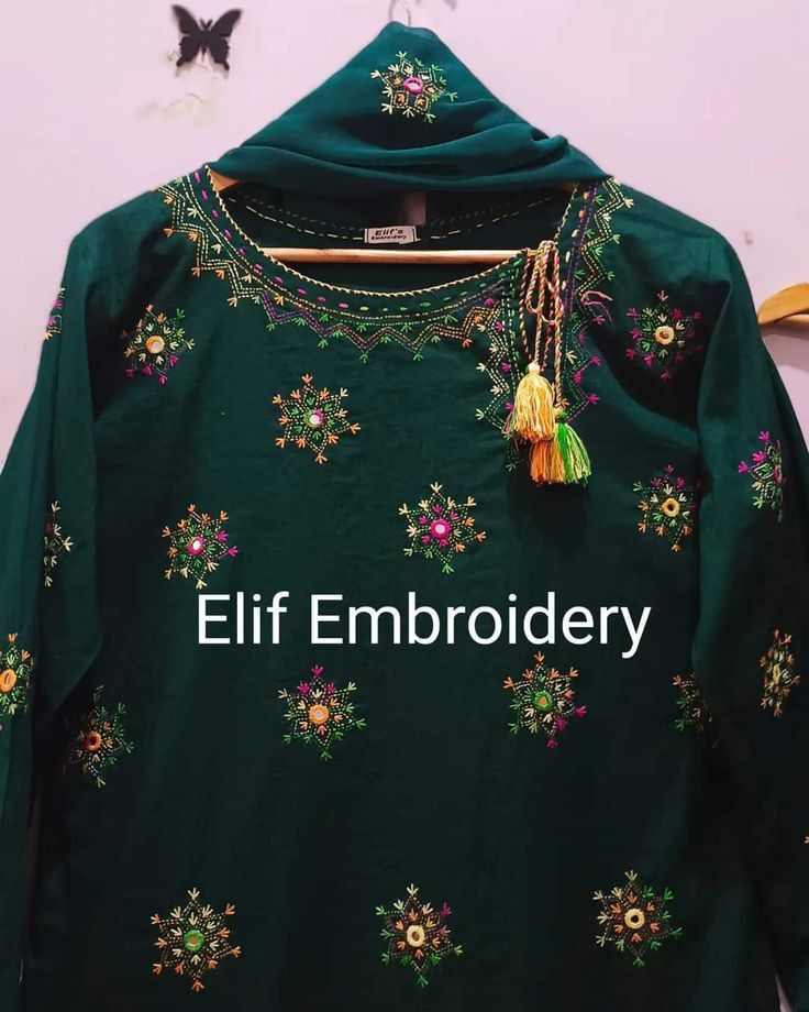 Green embroidered garment with tassels .